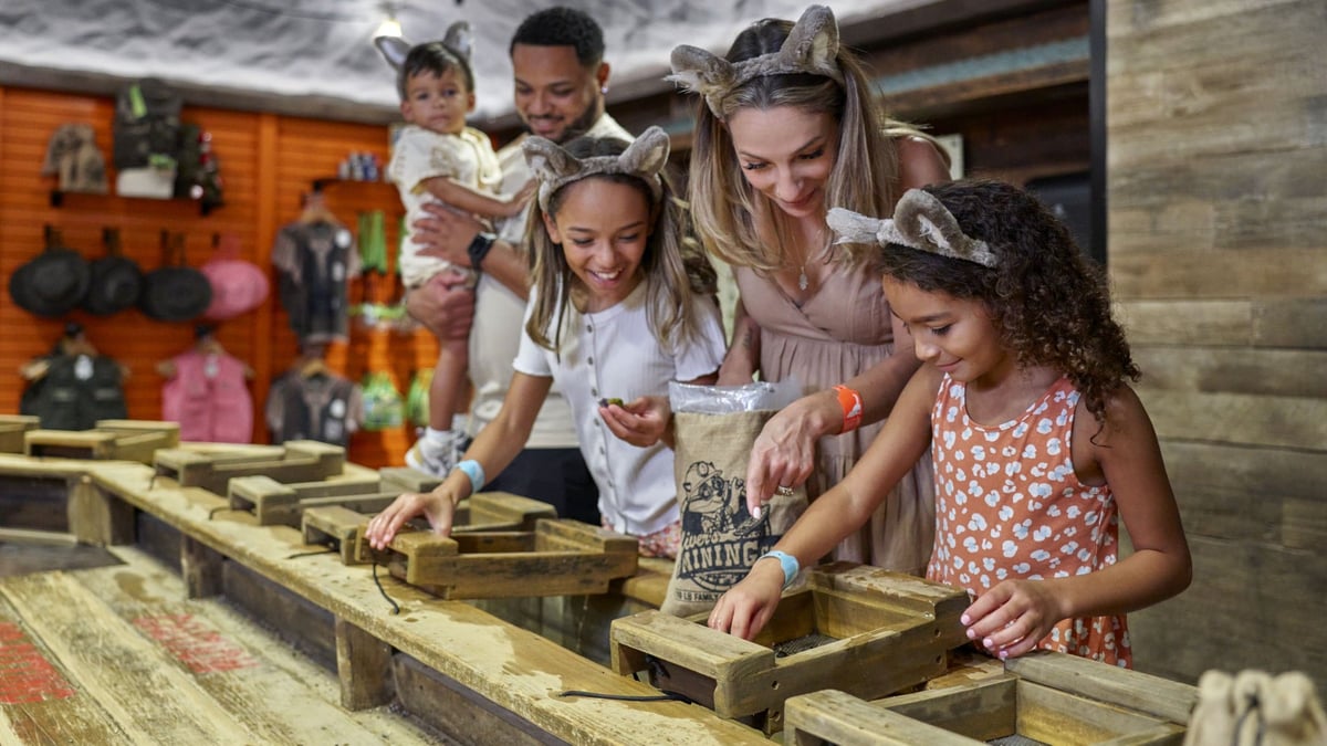 Family gem mining together at indoor station