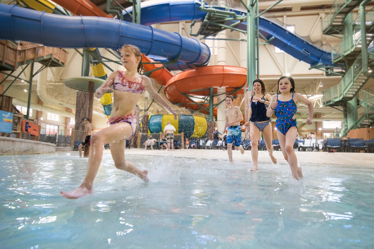 family enjoying as they get splashed with water in a water park fort