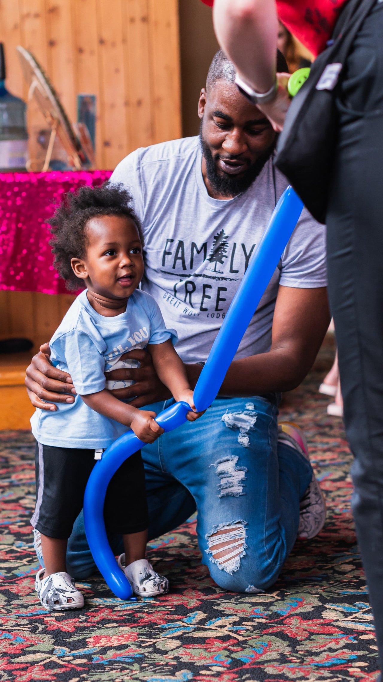 Child holding a blue color balloon