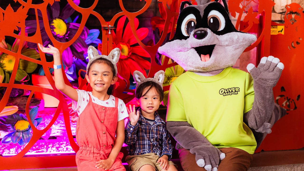 Children posing with mascot