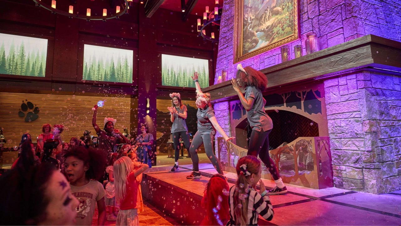Performers and children playing with bubbles in a vibrant setting