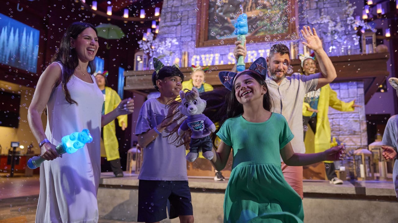 A family playing with bubbles in a lively, colorful setting