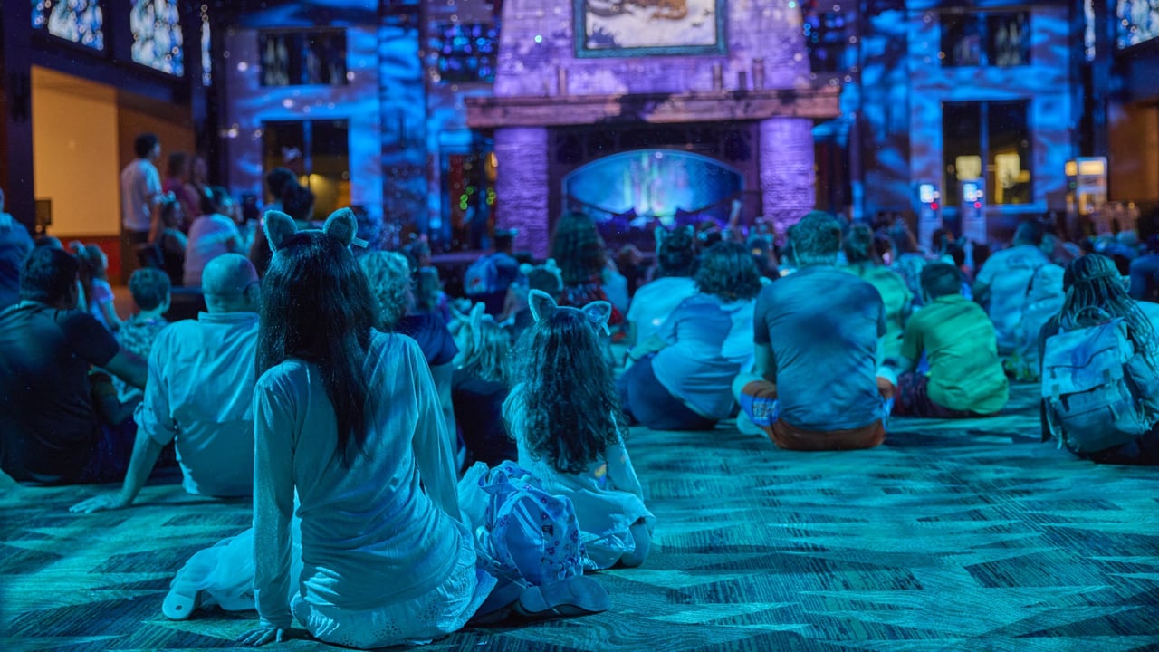 Families with children enjoy magical storytime by glowing fireplace