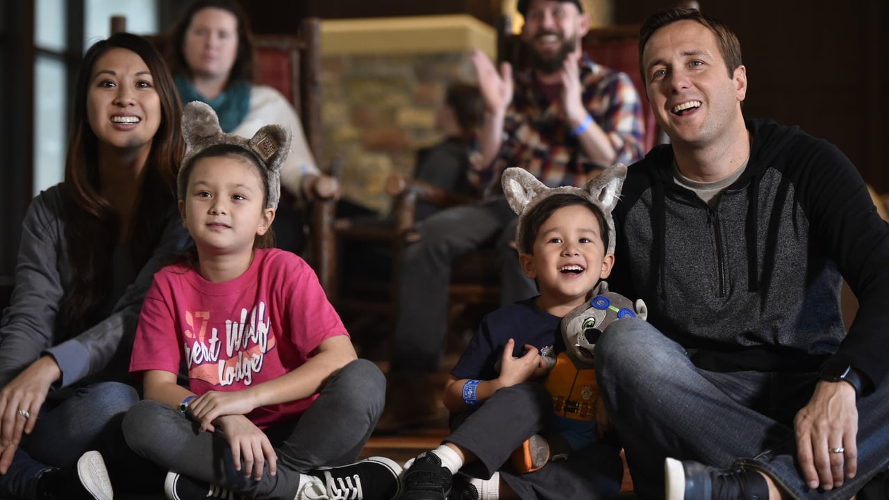 a family sitting together and watching a movie