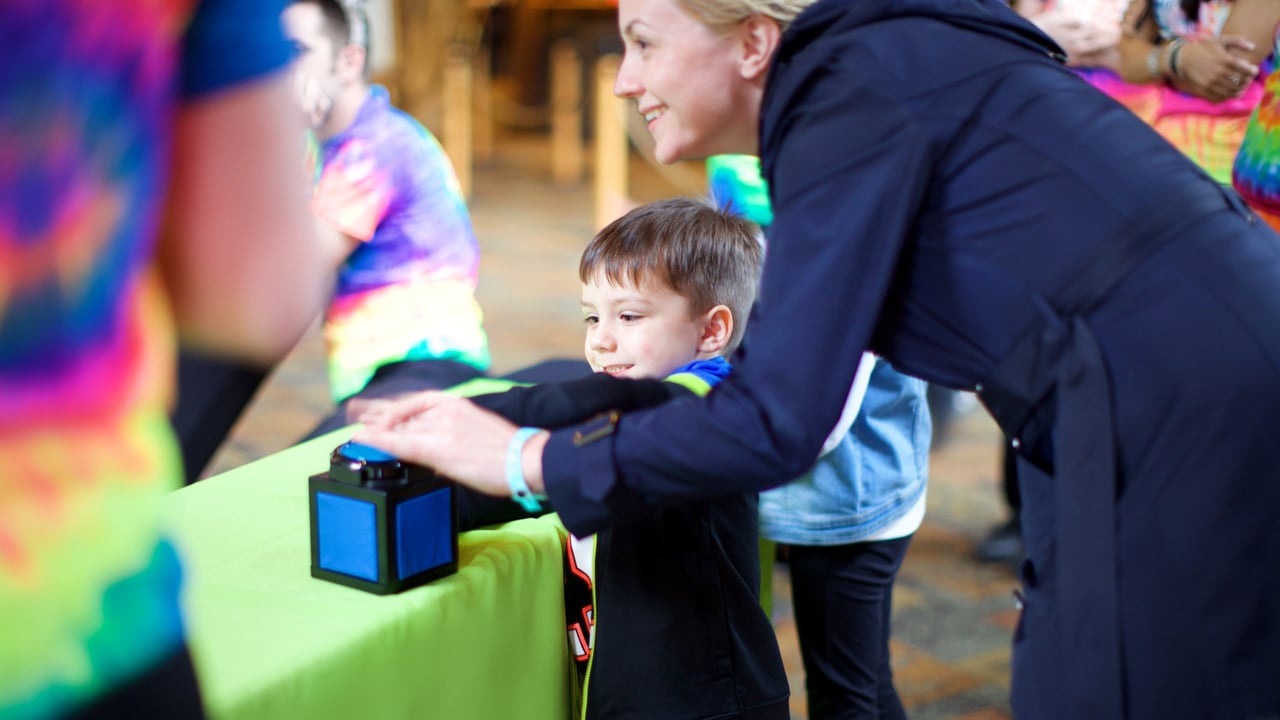 Child participating in trivia game with her mother