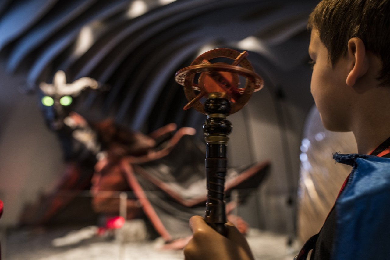 A close up of boy holding his MagiQuest wand.