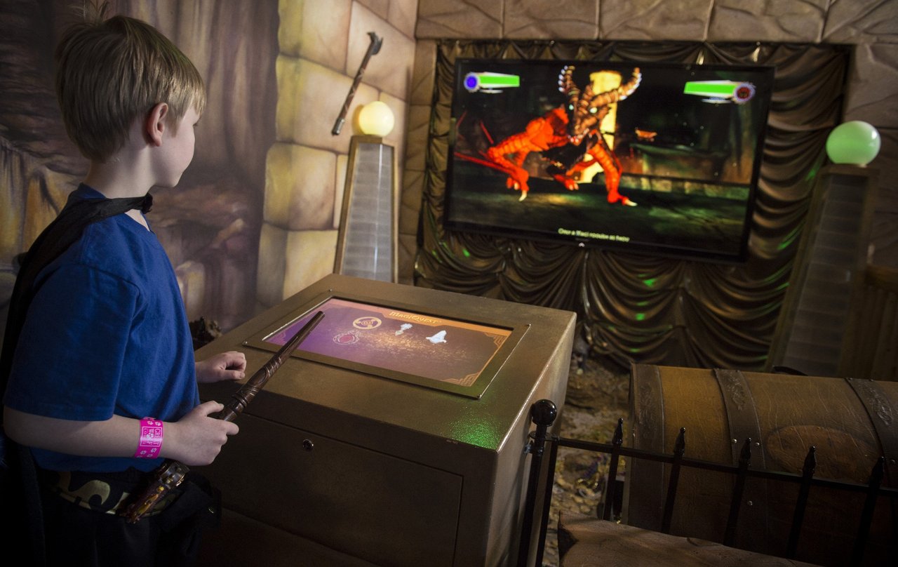A young boy interacting with a MagiQuest game.