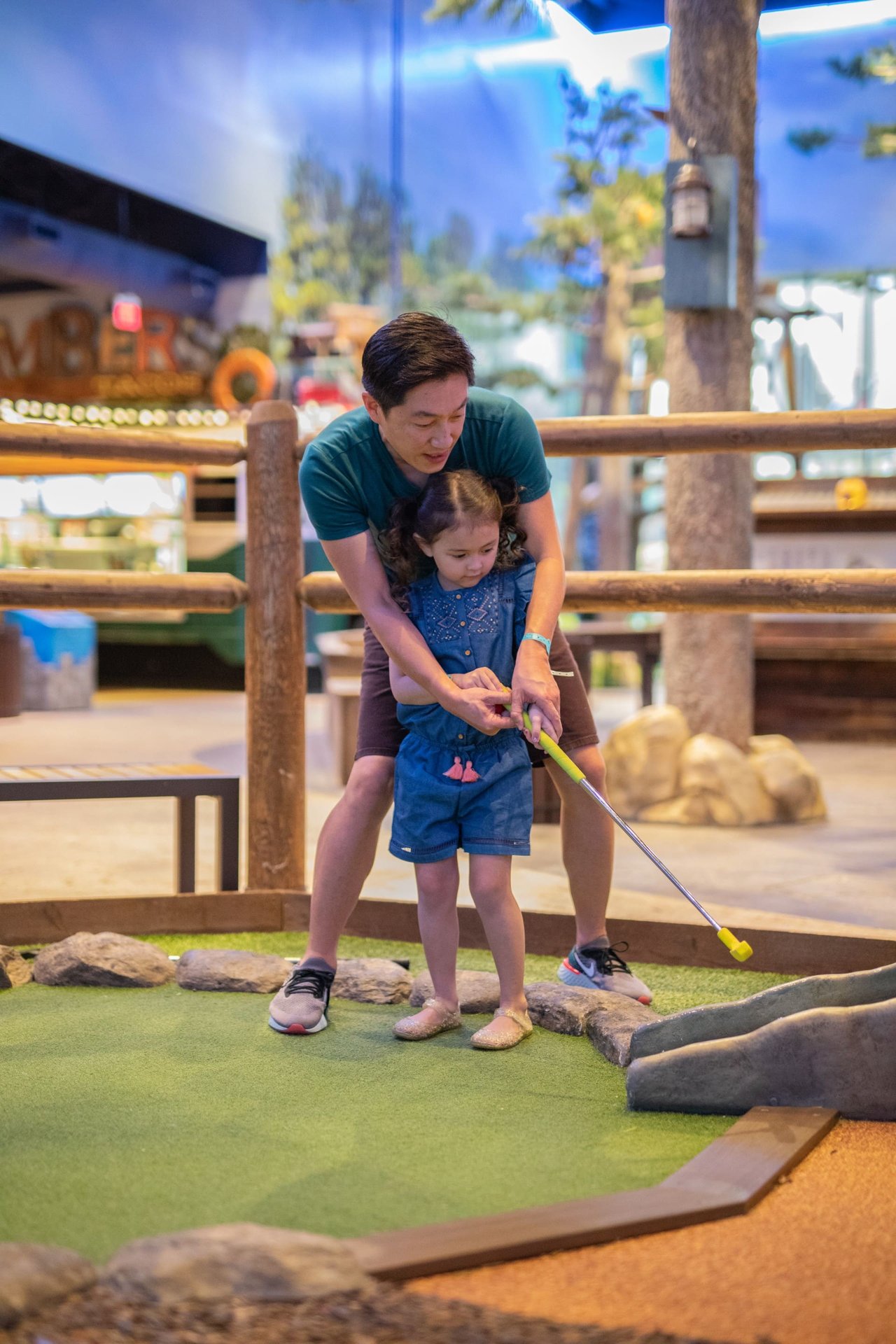 Father teaching her daughter how to play