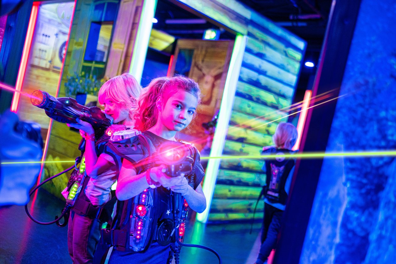 girl hiding while playing laser tag