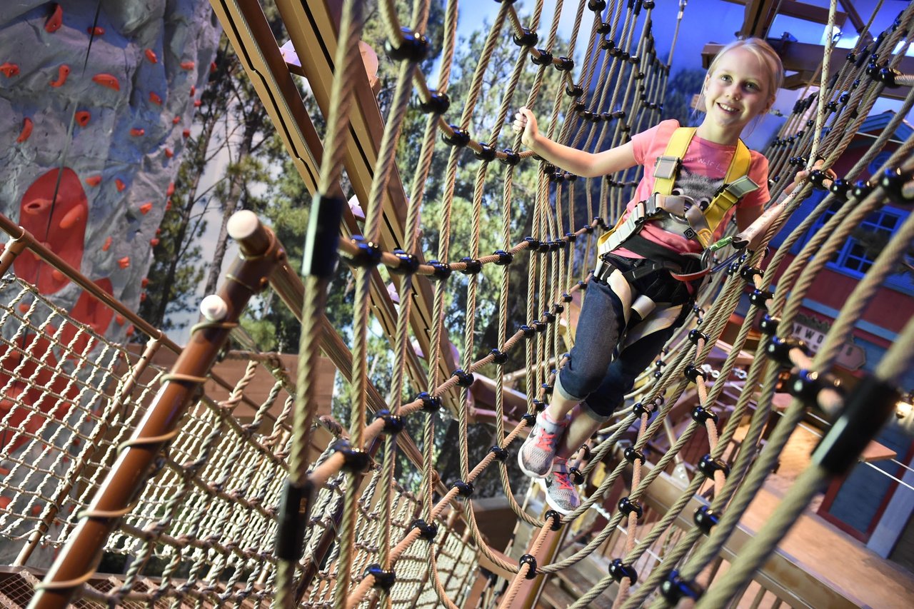 Girl trying to cross the ropes course