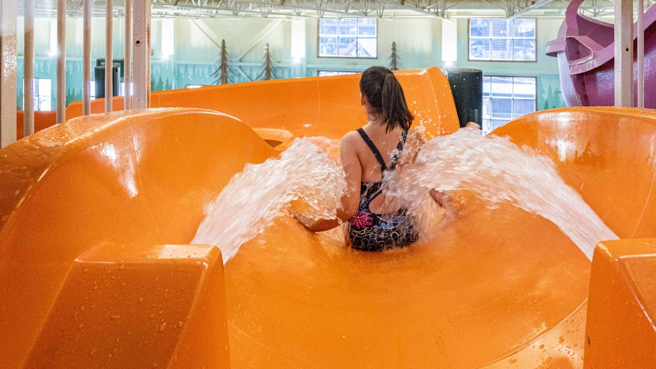 mother going down an orange body slide