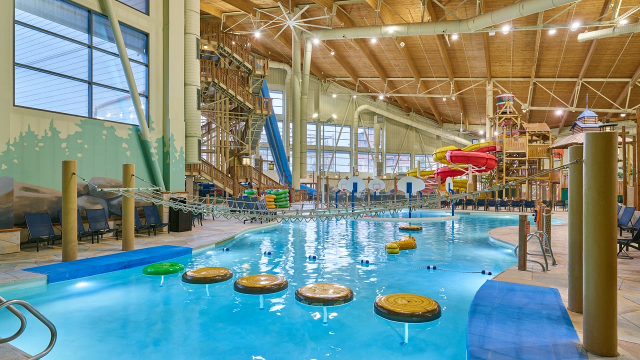 A large indoor water park featuring multiple colorful slides and a spacious pool area
