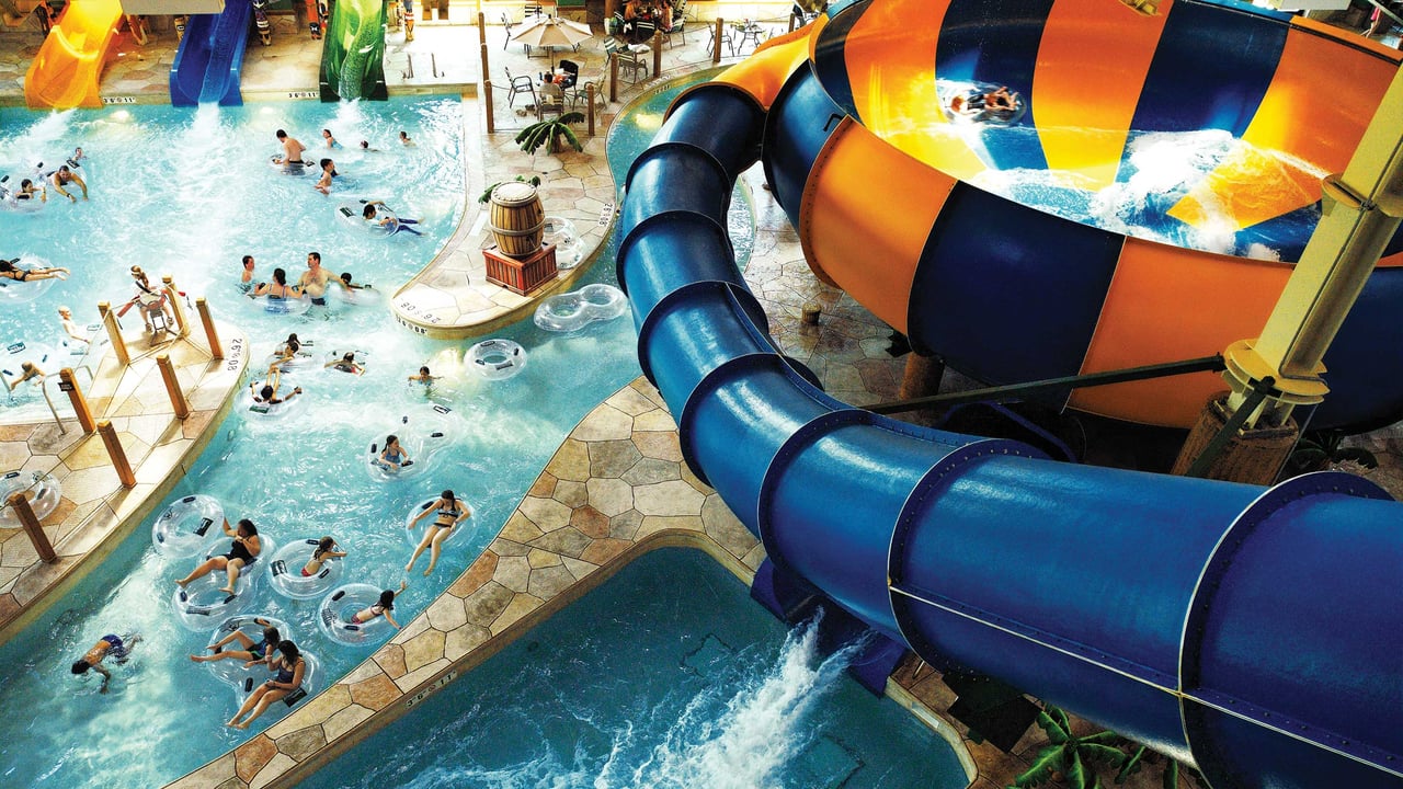 An aerial view of the Canada Vortex water slide and people floating in the splash pool.
