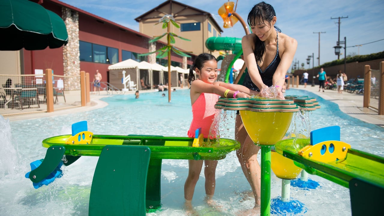 mother and daughter playing with water