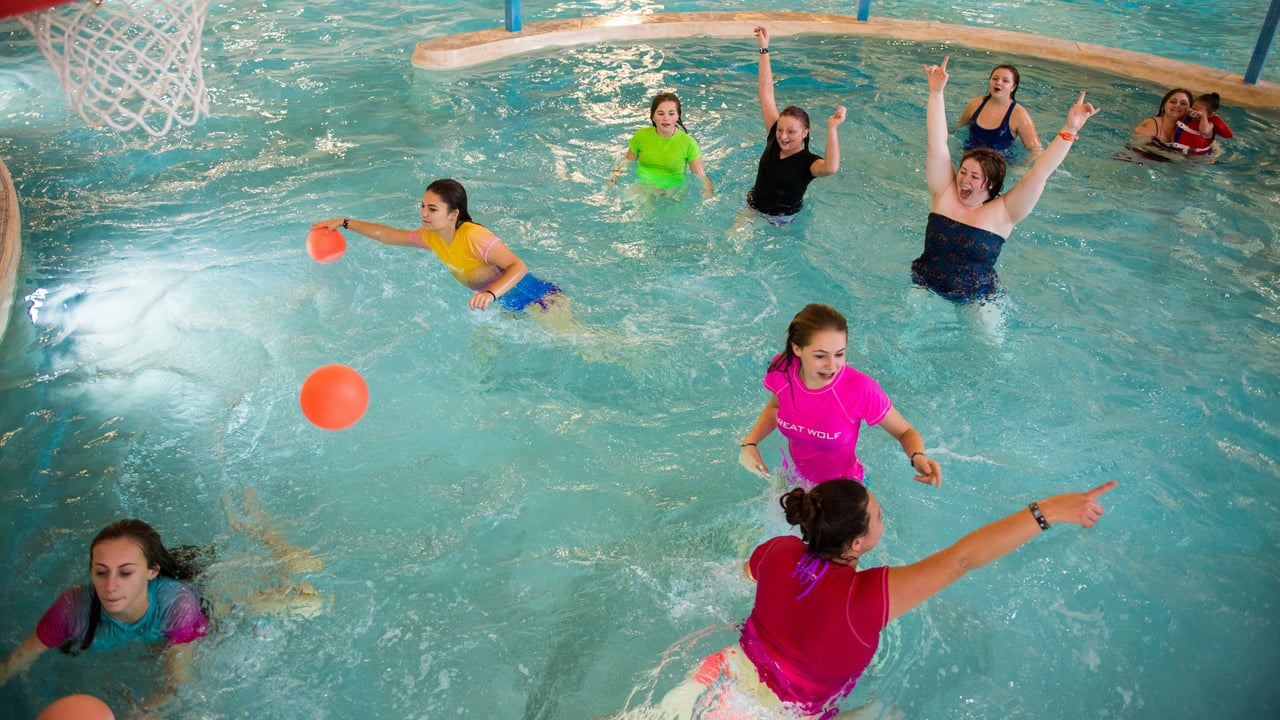 group of friends playing basket ball in an indoor pool