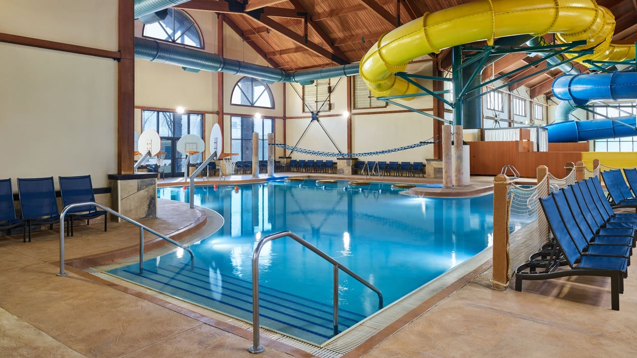 A large indoor pool equipped with a colorful water slide