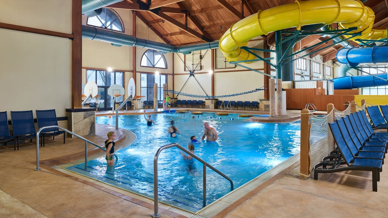 group of friends playing basketball in an indoor pool