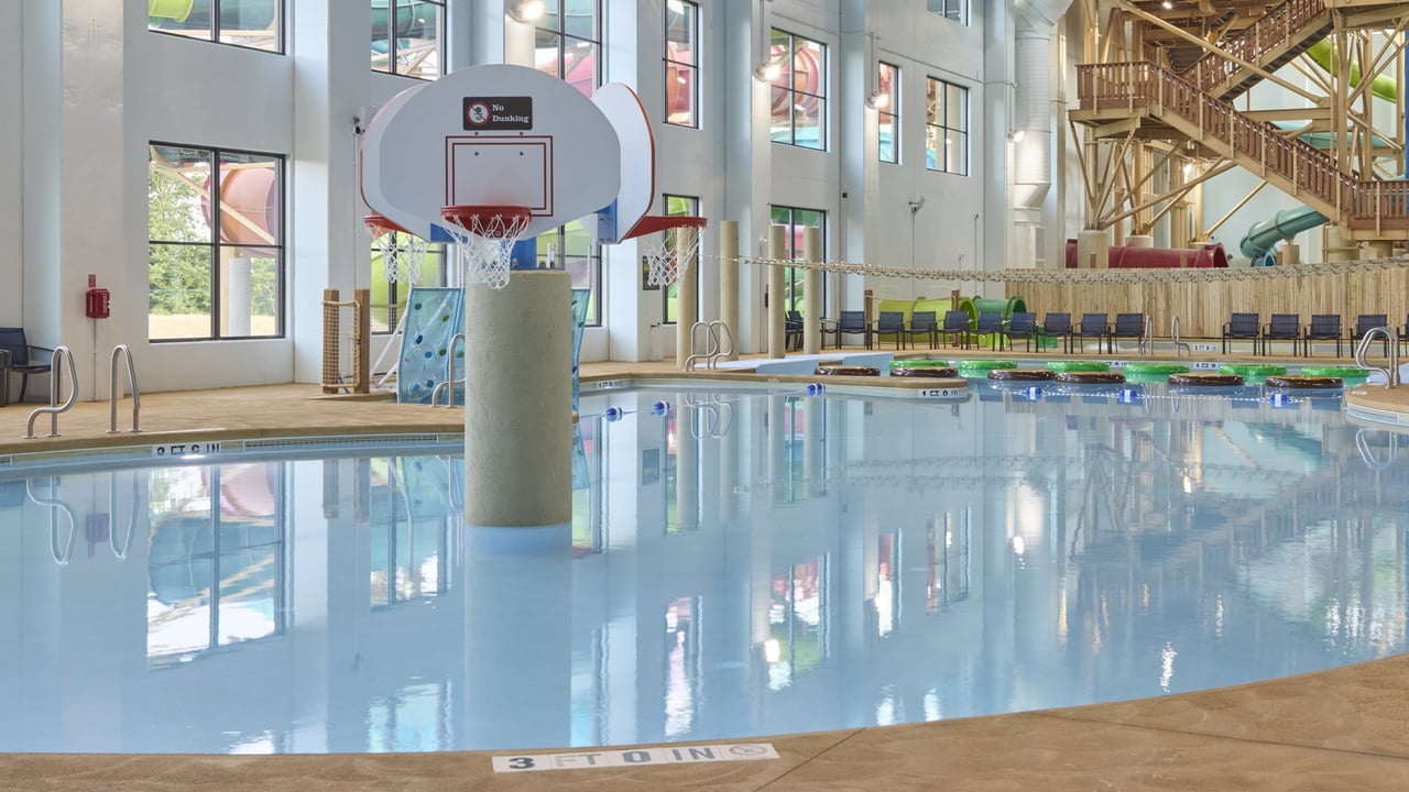 A large indoor pool equipped with a colorful water slide