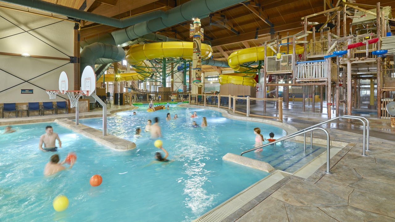 Families enjoying in the indoor water park pool