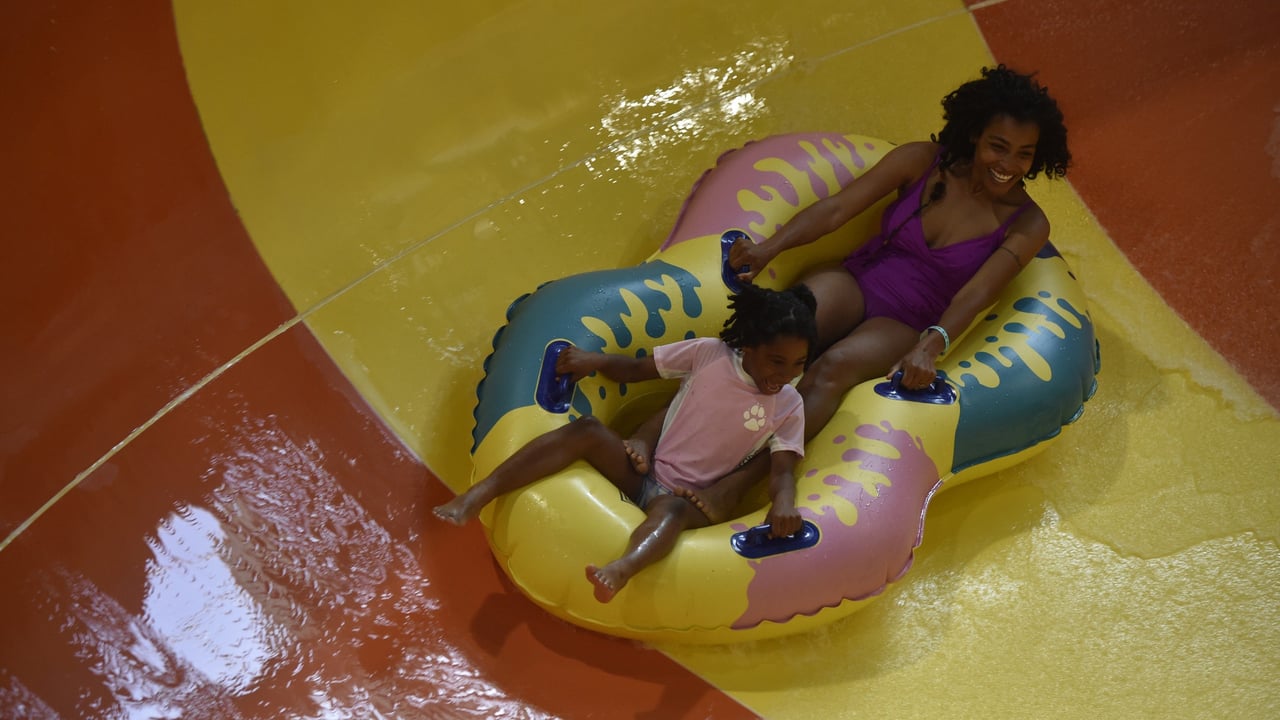 mother and daughter on a double tube water slide