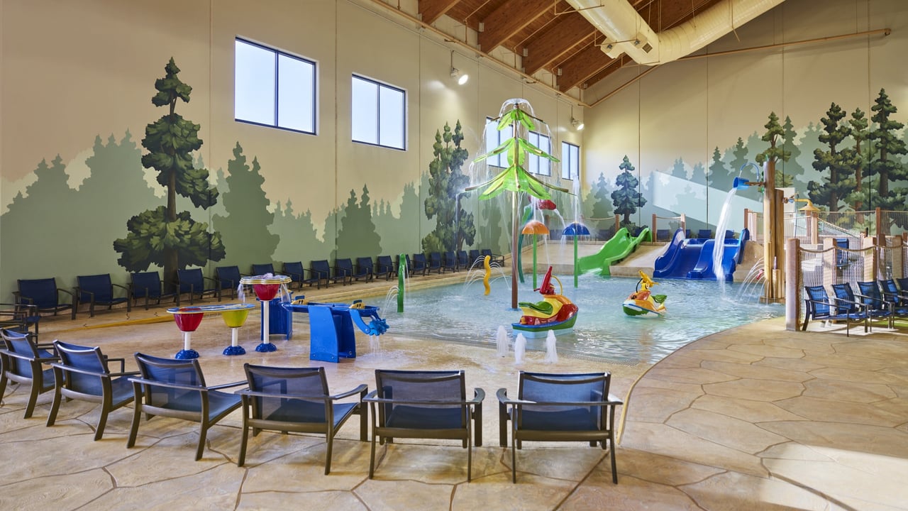 A large indoor water park featuring multiple water slides