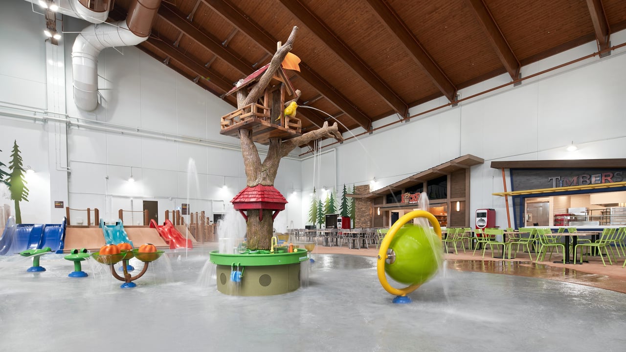 A vibrant water park featuring colorful slides and a fun water play area for children