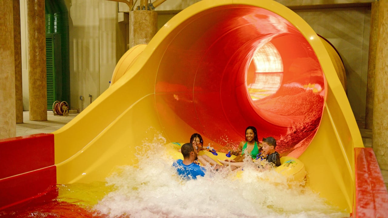 Picture of a couple splashing down at the end of the Howlin' Tornado funnel slide