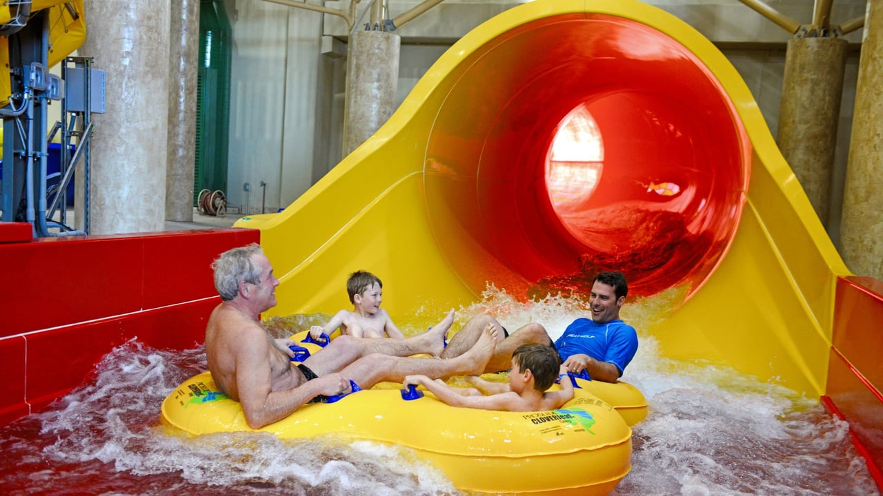 Picture of family splashing down at the end of the Howlin' Tornado funnel slide