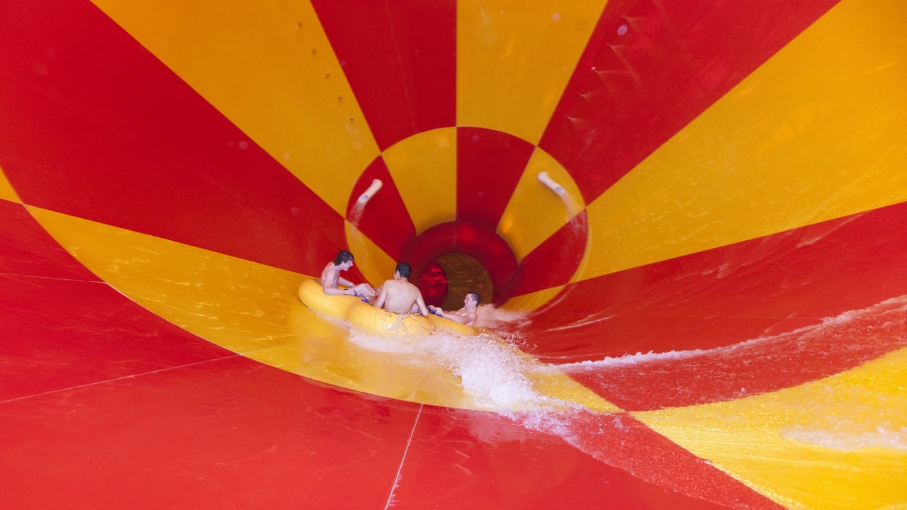 Image of people in inner tube sliding down the Howlin' Tornado funnel slide