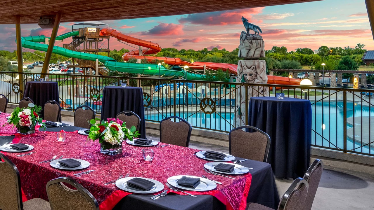 view of an outdoor water park with a pool and water slides