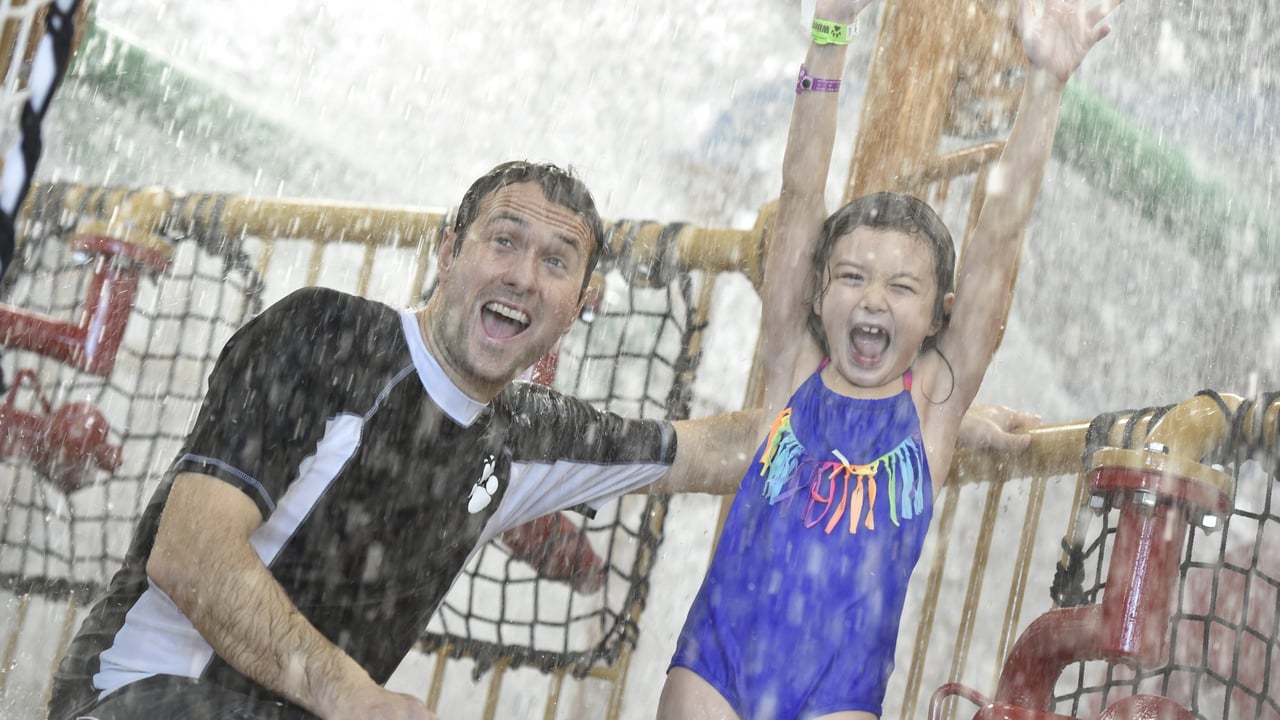 daughter and father laughing as they enjoy the water fort