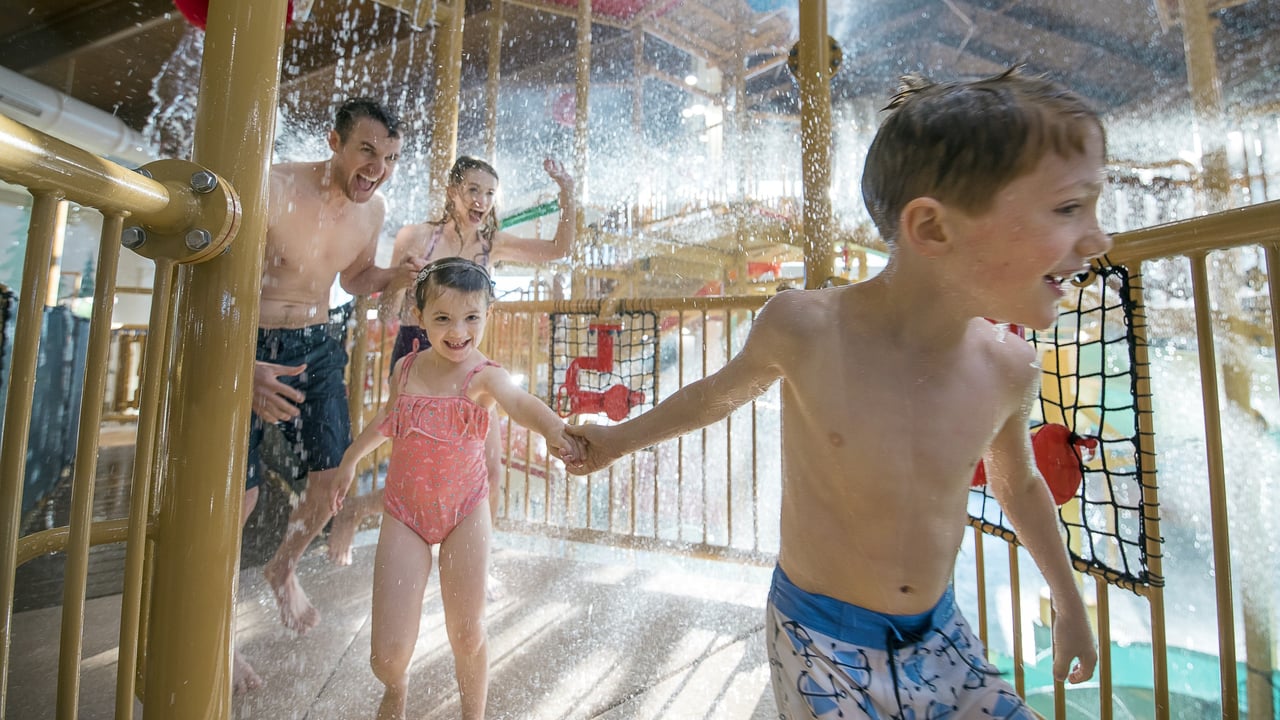 family enjoying playing inside the water fort