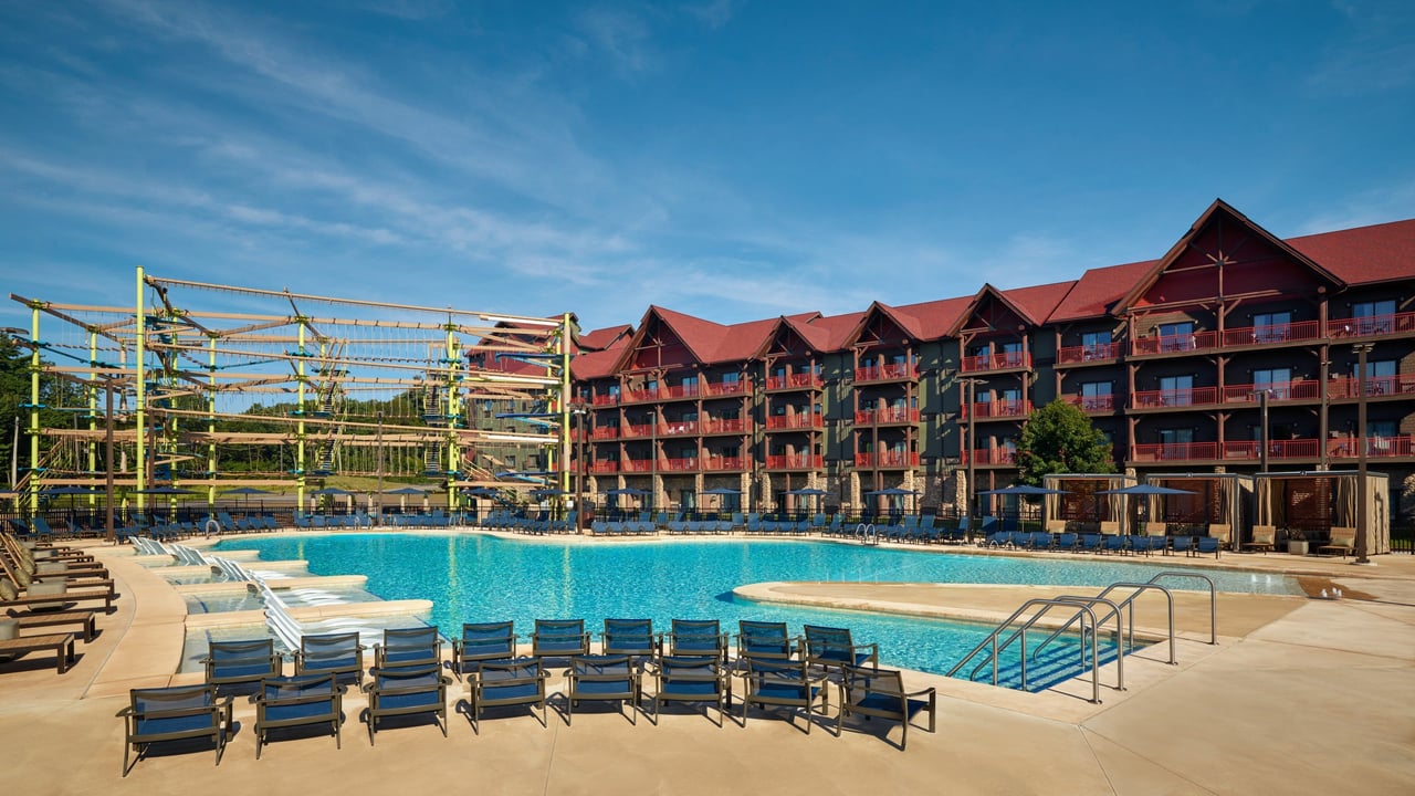 view of an outdoor pool and outdoor ropes course in the Poconos