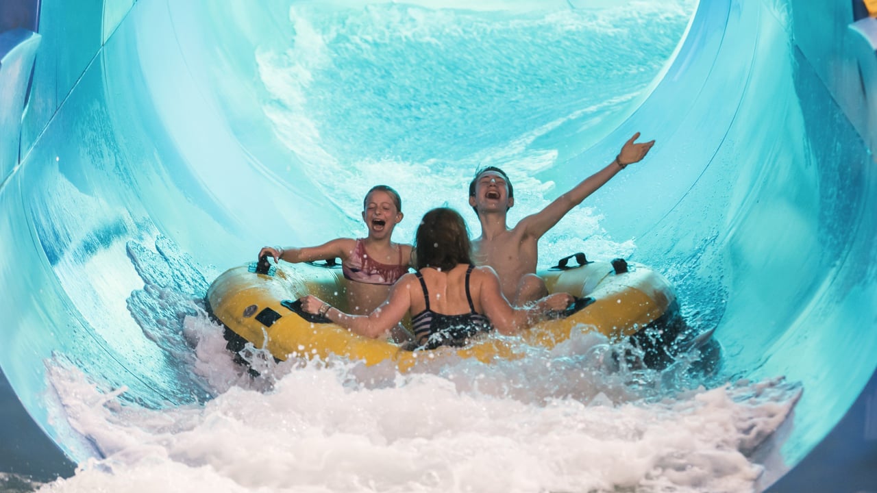 family in a yellow raft heading to the landing pool