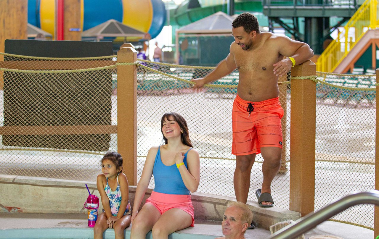 parents and daughter sitting new the hot tub