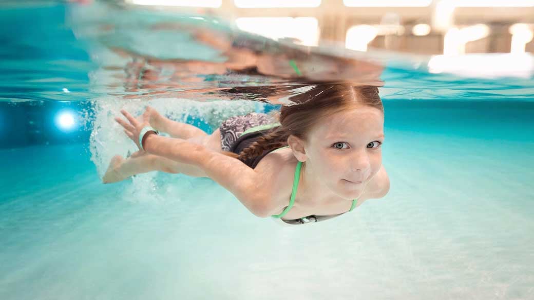 Little girl swiming in a pool