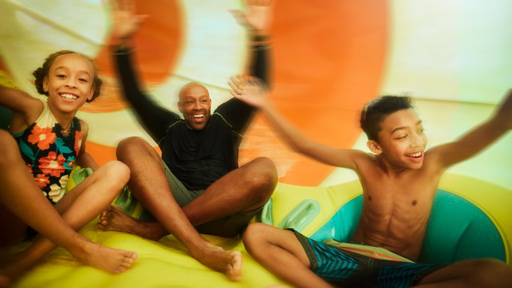 Family having fun together on a waterslide