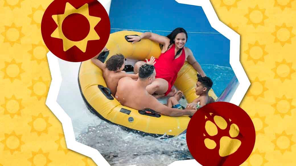 Family sliding down a water slider in a yellow floats