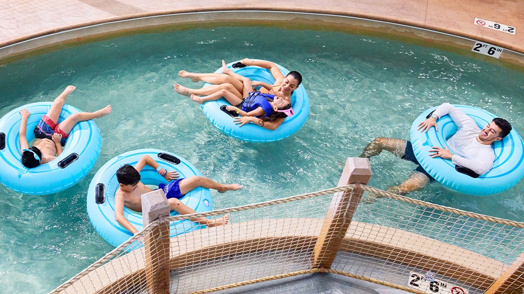Family and kids enjoying a lazy river at Great Wolf Lodge