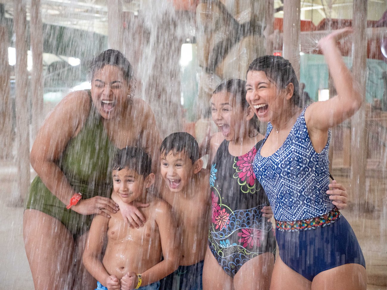Family of five enjoying the indoor water park at Great Wolf 