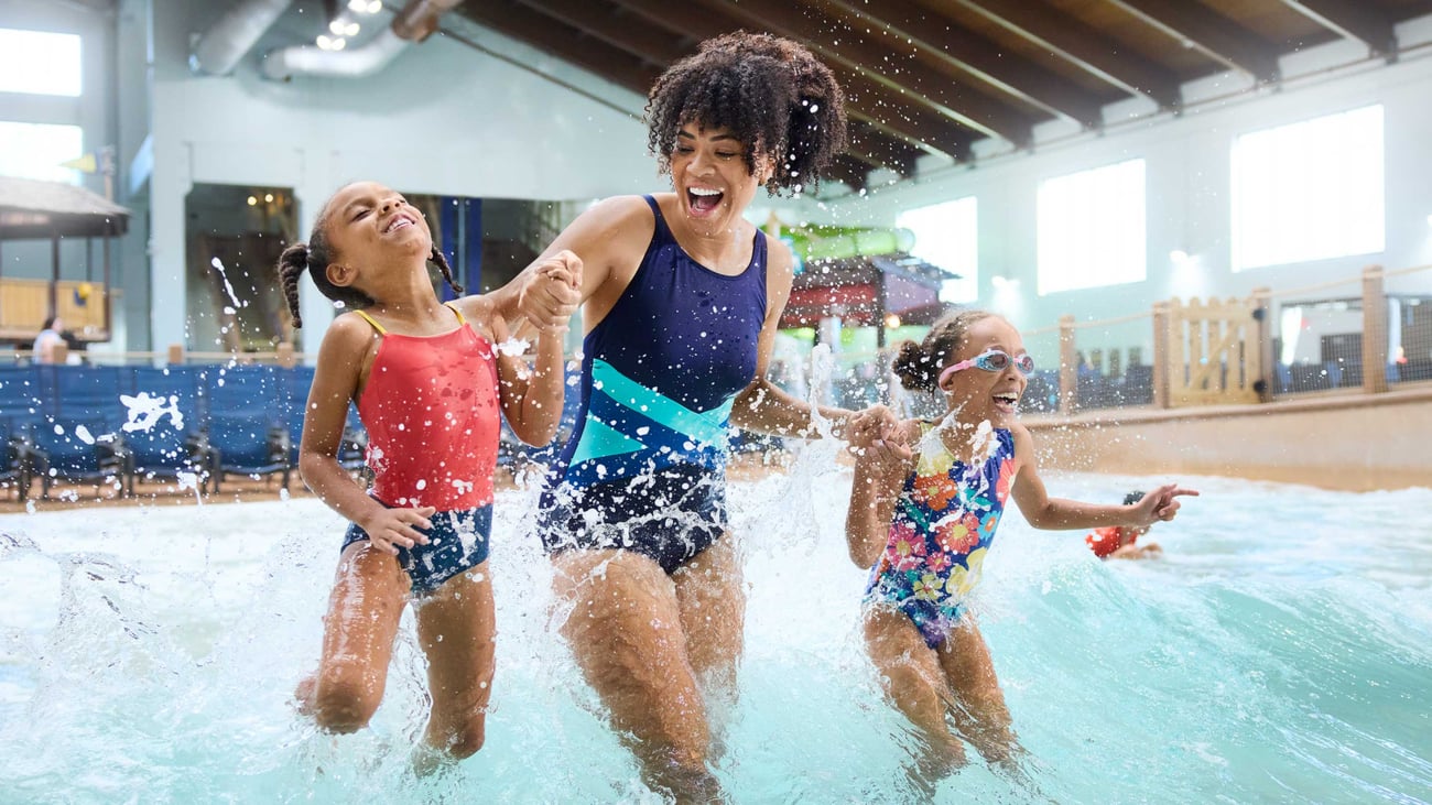 Mother and daughters enjoying an indoor wave pool
