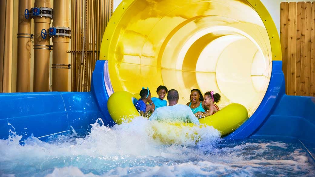 family sliding down a water slide at Great Wolf Lodge