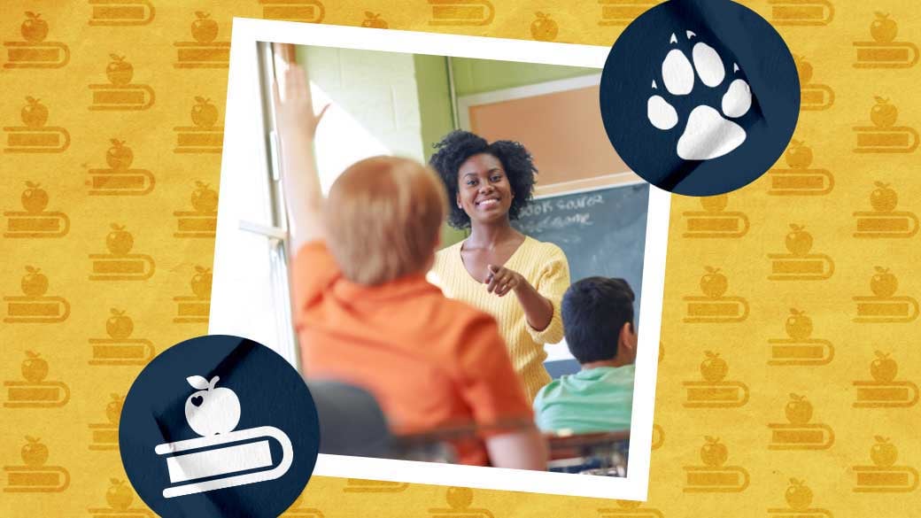 Teacher pointing at a student who raised their hand in classroom