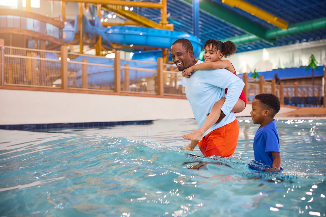 father along with son and daughter enjoying in a wave pool
