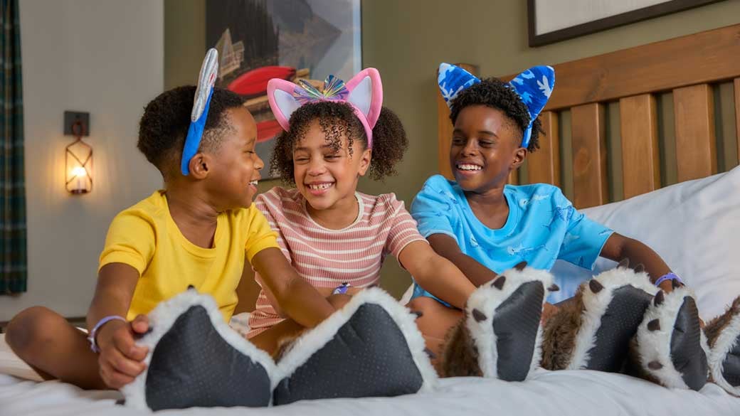 kids sitting on bed and smiling