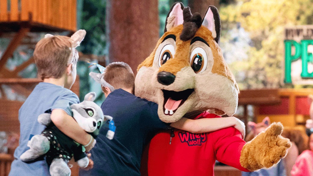 Wiley hugging two boys