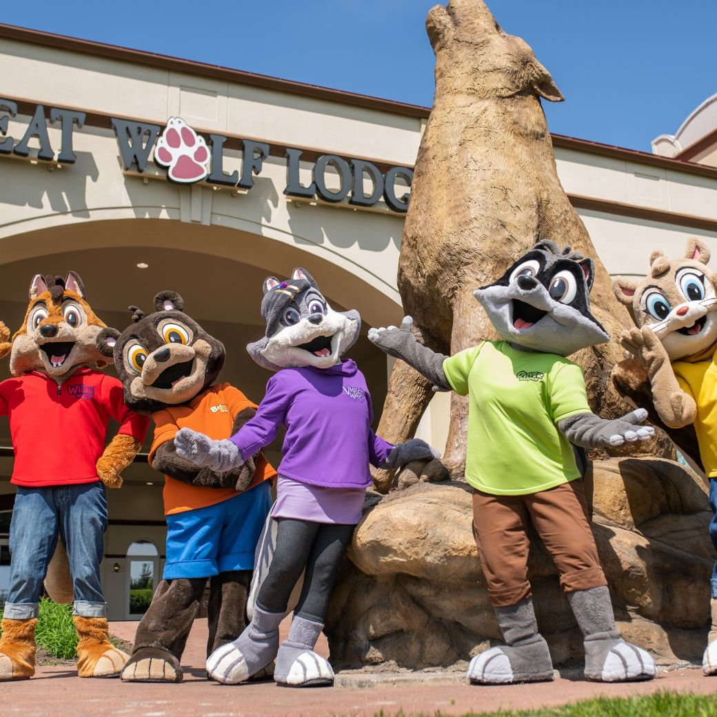 Great Wolf Lodge mascots posing in front of entrance statue