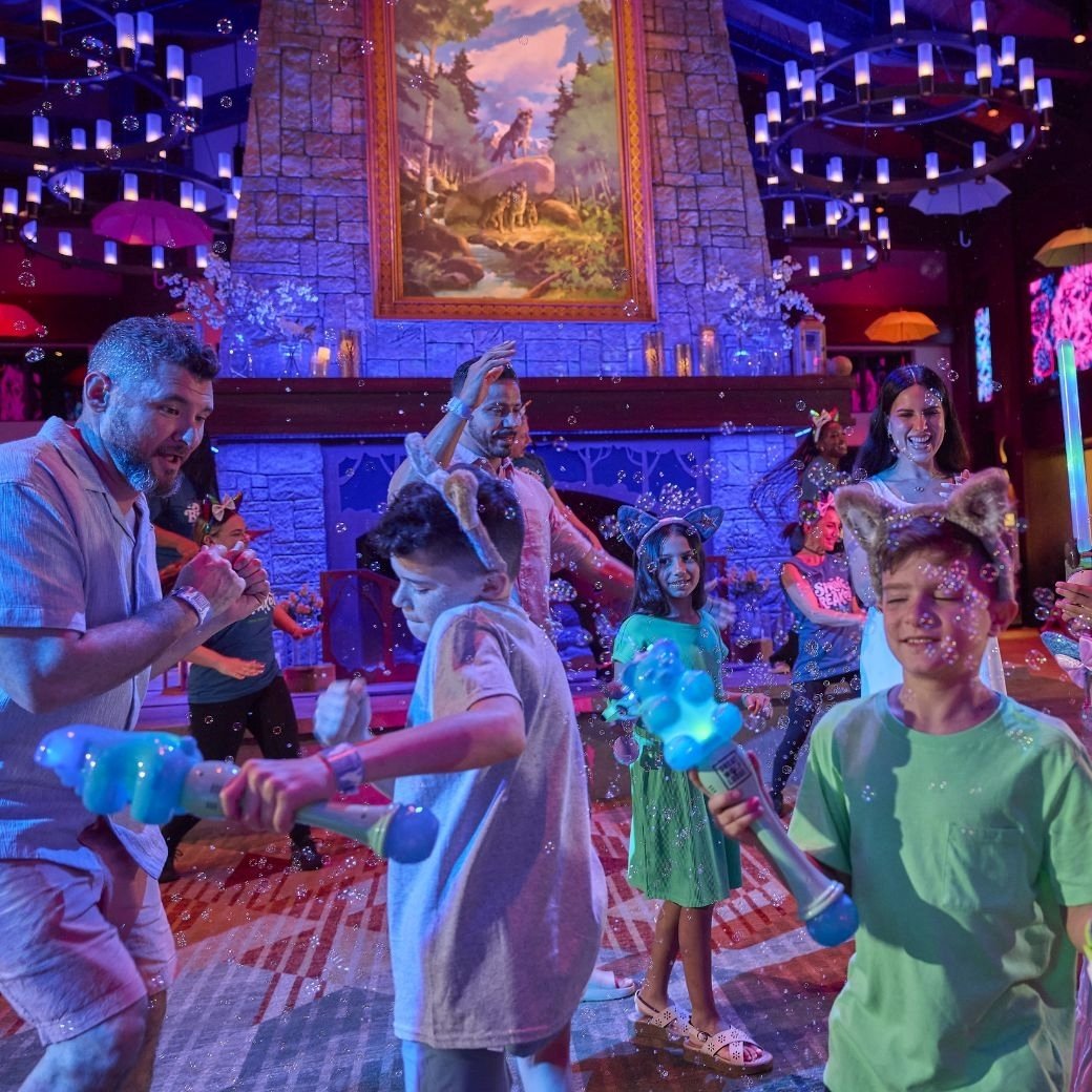 A family dancing and playing with bubbles in a fun setting
