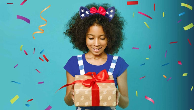 girl holding gift with confetti falling 