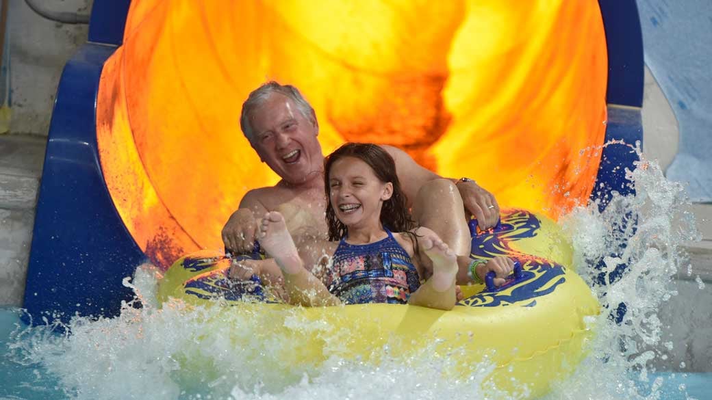 Grandfather and granddaughter on a slide